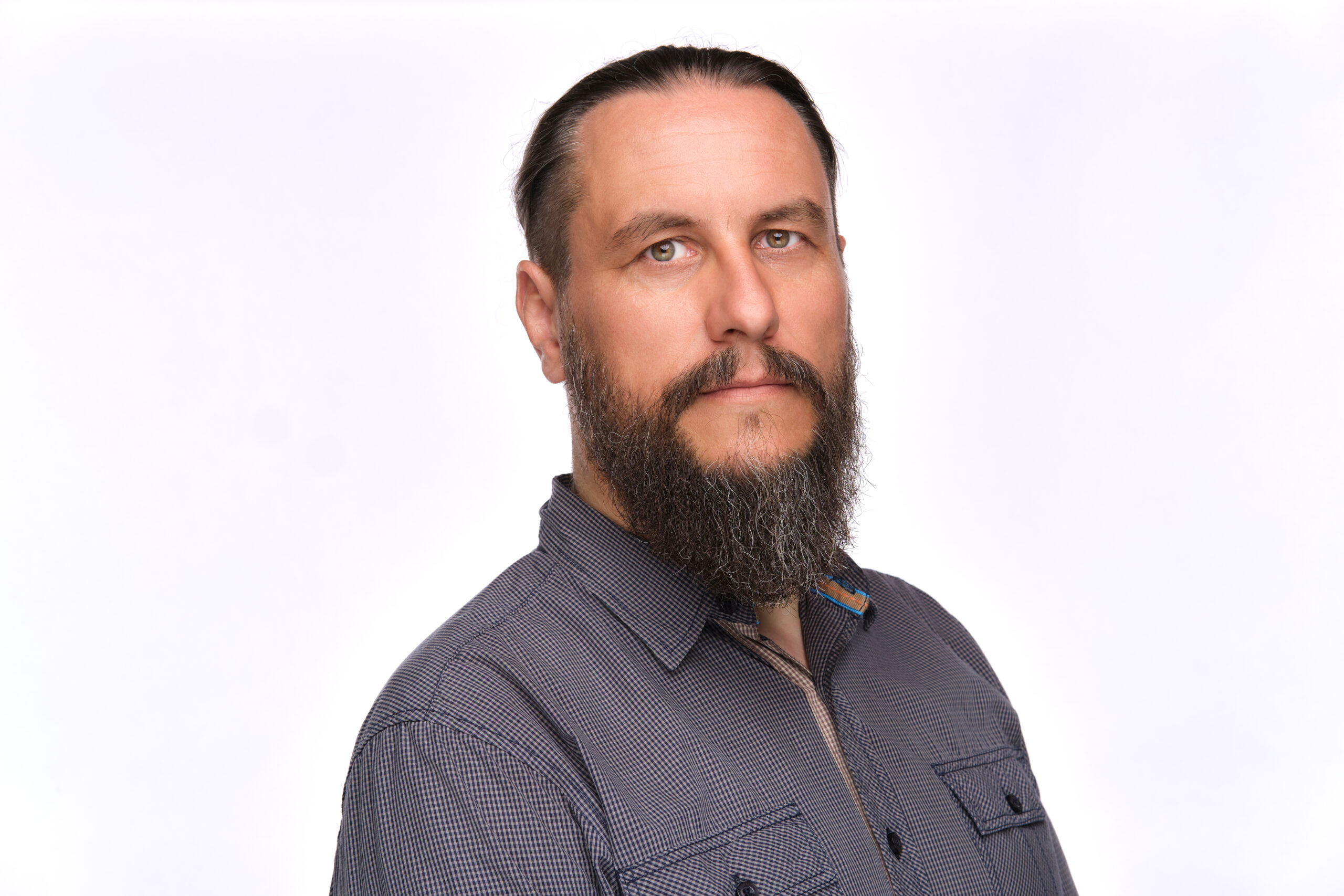 Man with long beard wearing dark grey shirt